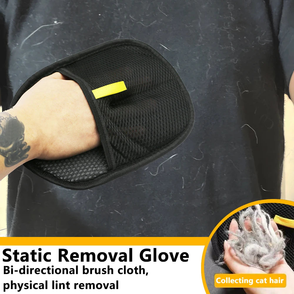 Black static removal glove with a yellow label, held by a person, on a dark surface.